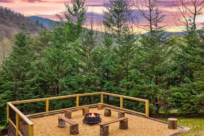 Firepit overlooking layered north Georgia mountain ridges at sunset
