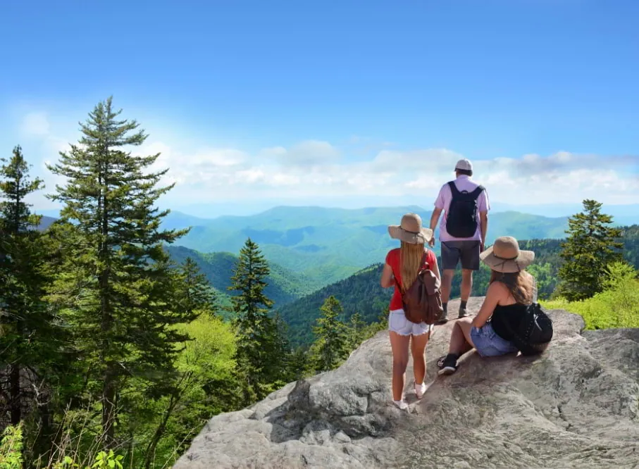 Hikers taking in the Blue Ridge mountain view from a rocky overlook